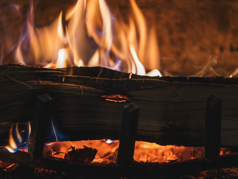 Close-up of burning logs in a wood-burning fireplace
