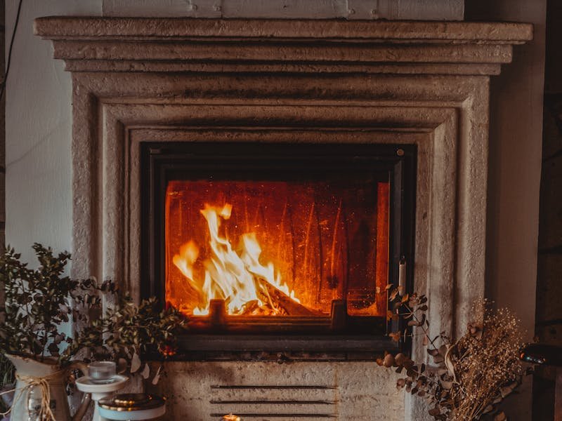 Elegant stone-surround fireplace with hearth and decor